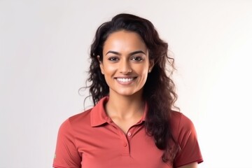 Fototapeta premium Medium shot portrait of an Indian woman in her 30s wearing a sporty polo shirt against a white background
