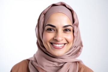 Medium shot portrait of an Indian woman in her 30s wearing hijab against a white background