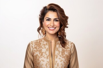 Fototapeta premium Medium shot portrait of an Indian woman in her 30s wearing sherwani against a white background