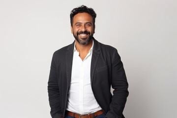 Medium shot portrait of an Indian man in his 30s against a white background