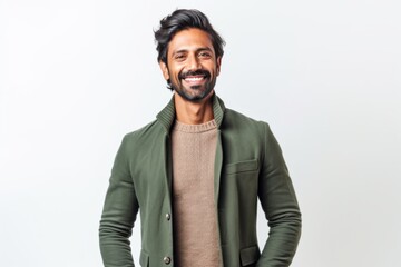 Lifestyle portrait of an Indian man in his 30s against a white background