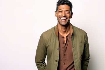 Obraz premium Lifestyle portrait of an Indian man in his 30s against a white background