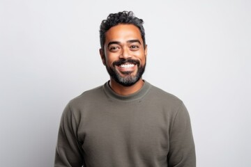 Medium shot portrait of an Indian man in his 30s wearing hijab against a white background