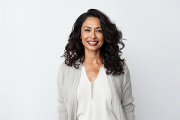 Medium shot portrait of an Indian woman in her 40s against a white background