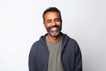 Obraz premium Medium shot portrait of an Indian man in his 40s against a white background