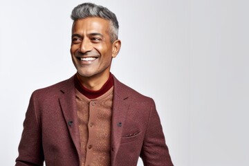 Lifestyle portrait of an Indian man in his 40s against a white background