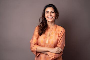 Group portrait of an Indian woman in her 30s wearing kurta pajama in a minimalist background