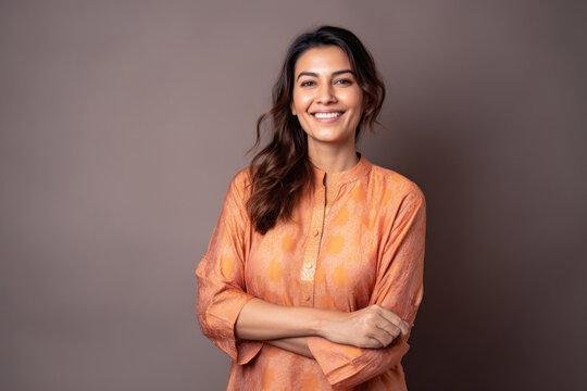 Group portrait of an Indian woman in her 30s wearing kurta pajama in a minimalist background