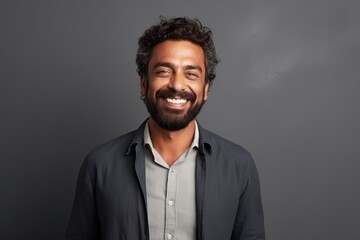 Fototapeta premium Medium shot portrait of an Indian man in his 30s in a minimalist background