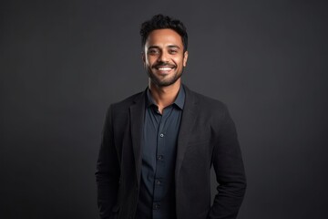 Medium shot portrait of an Indian man in his 30s in a minimalist background