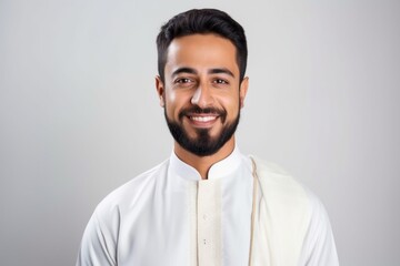 Obraz premium Medium shot portrait of an Indian man in his 30s wearing hijab in a minimalist background