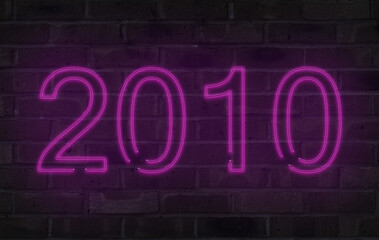Purple 2010 neon sign on a brick wall