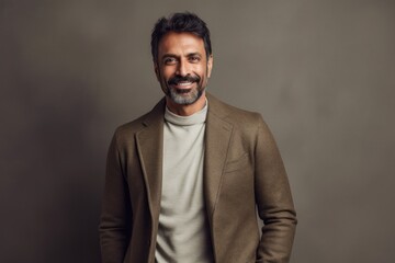 Obraz premium Lifestyle portrait of an Indian man in his 40s in a minimalist background