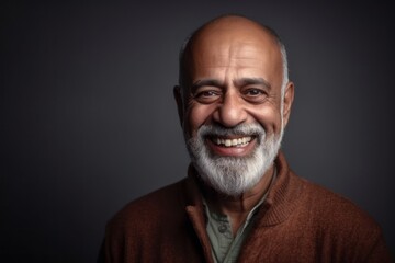 Fototapeta premium Medium shot portrait of an Indian man in his 50s in a minimalist background
