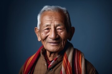 Fototapeta premium Medium shot portrait of an 100-year-old elderly Indian man in a minimalist background