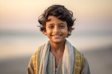 Medium shot portrait of an Indian child male in a beach 