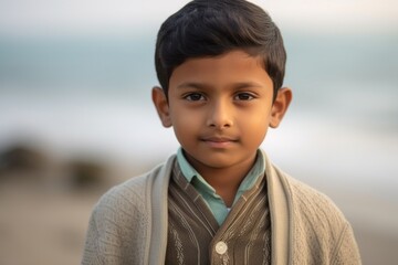 Close-up portrait of an Indian child male in a beach 