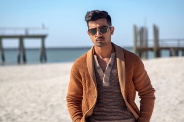 Lifestyle portrait of an Indian man in his 20s in a beach 