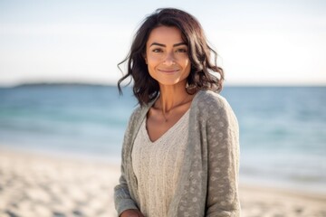 Lifestyle portrait of an Indian woman in her 30s in a beach 