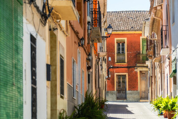 Fototapeta na wymiar Colored houses in the old town street of Bellús, Valencia (Spain)