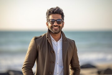 Group portrait of an Indian man in his 30s in a beach 