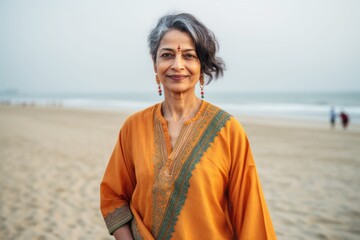 Portrait of a beautiful mature Indian woman in saree on the beach