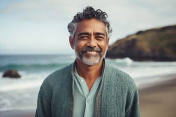 Portrait of smiling mature man standing at beach on a sunny day