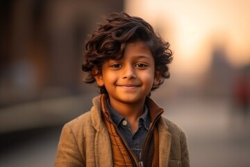 Portrait of a boy in the city at sunset. Selective focus.