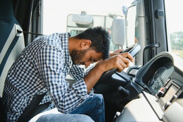 Exhausted truck driver falling asleep on steering wheel. Tiredness and sleeping concept