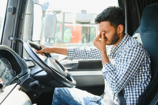 Portrait of tired indian truck driver feeling sleepy and sick