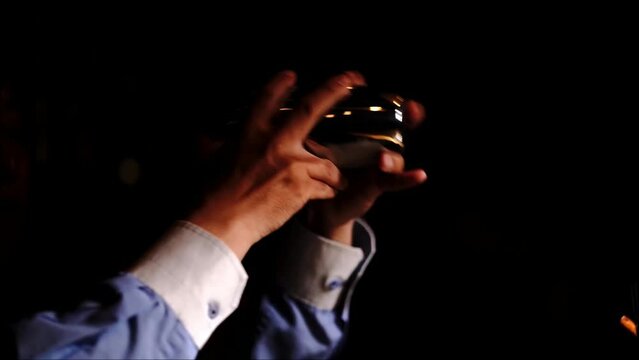 Professional bartender shaking a cocktail