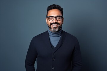 Obraz premium Portrait of a smiling indian man in black sweater and glasses