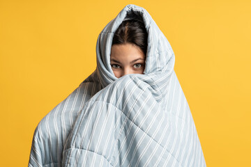 Teenage girl hid in gray blanket. Frightened brunette teen girl, covered, wrapped with thin, light,...