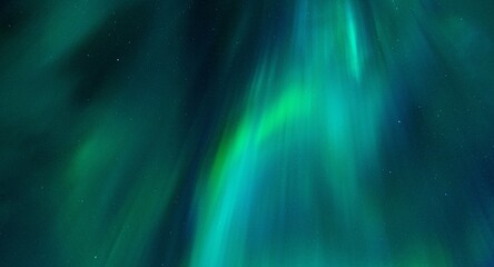 Beautiful night sky filled with an array of vibrant green northern lights or aurora borealis