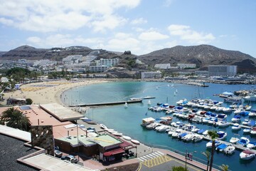 Fototapeta na wymiar Aerial shot of a coastline and marina in Puerto Rico resort town in Canary Island, Spain