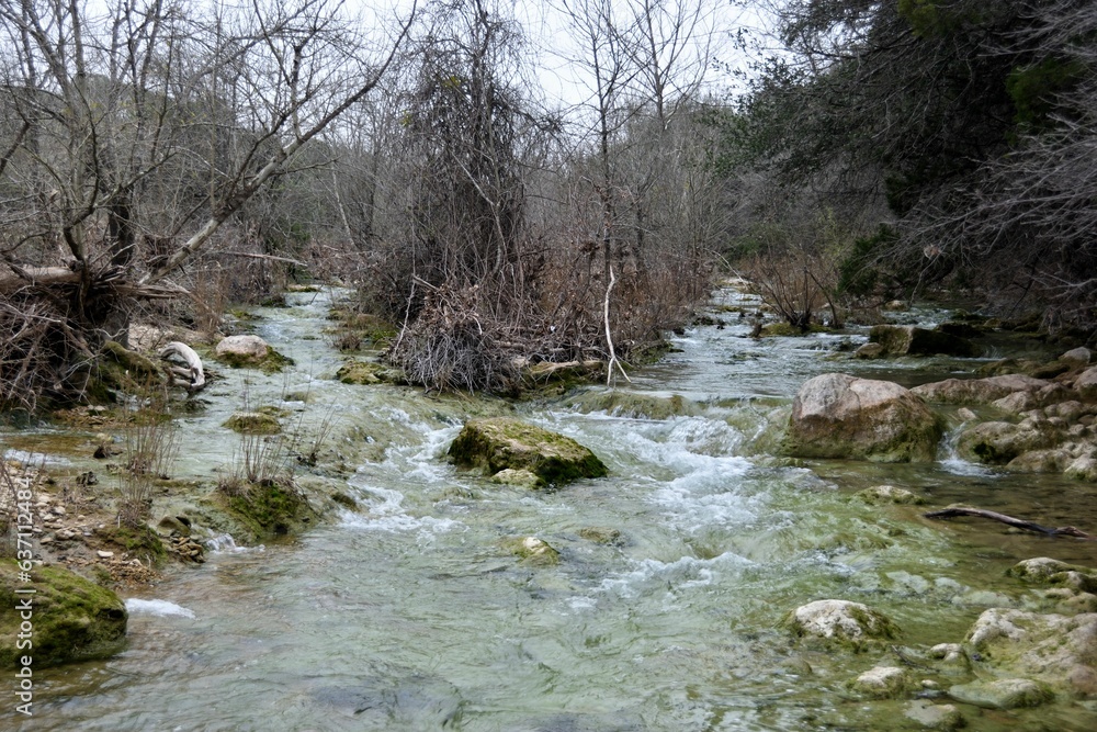 Aufkleber scenic view of a tranquil stream surrounded by large rocks and trees