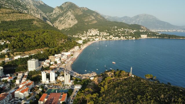 Aerial view of a coastal town of Sutomore between grassy hills