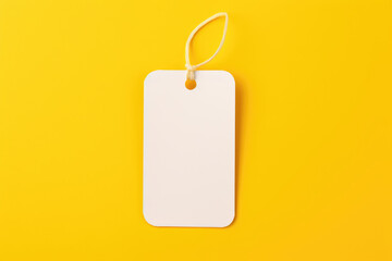 A mock-up of a white empty tag with a rope on a yellow background