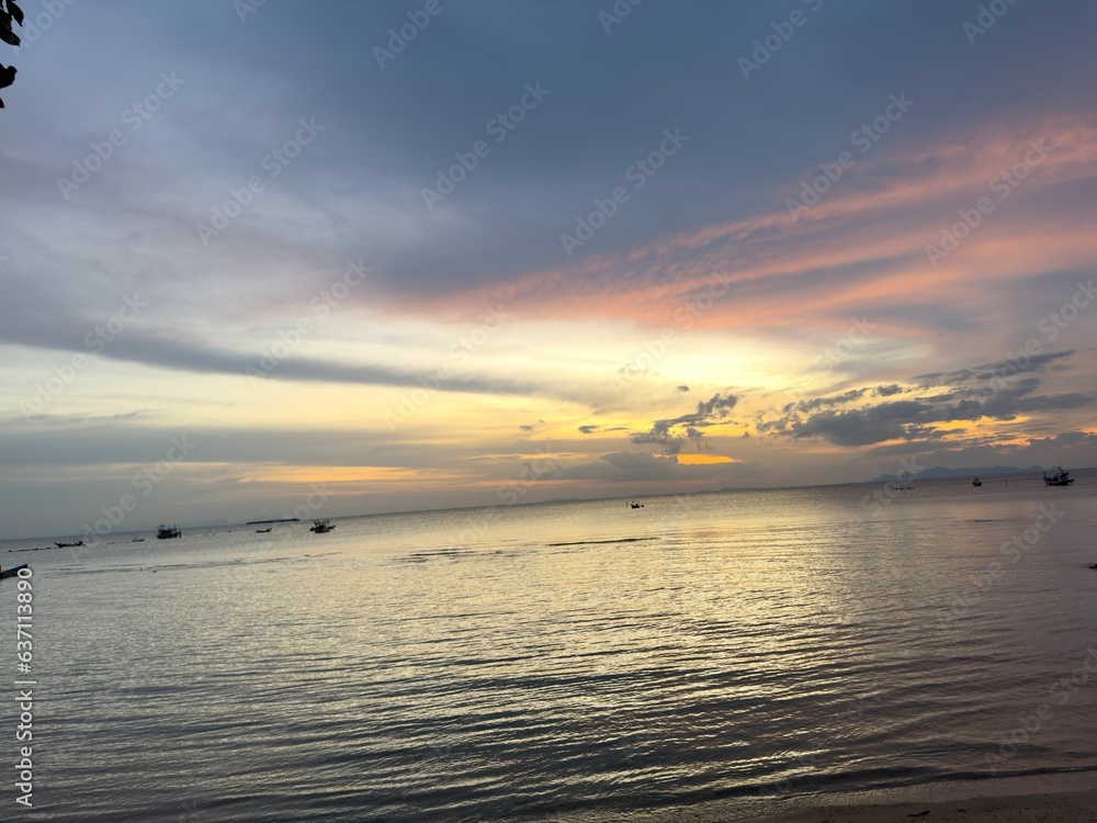 Canvas Prints Tranquil beach scene with a picturesque sunset illuminating the horizon