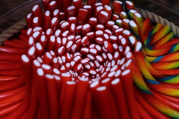 Diverse selection of colorful candy sticks in a bowl