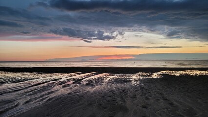 Scenic view of a beautiful sunset over Lake Ontario and a sandy beach in Canada