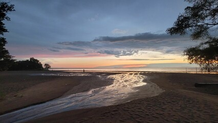 Scenic view of a beautiful sunset over Lake Ontario and a sandy beach in Canada