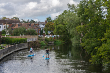 Fordingbridge, UK - August 19th 2023: Paddleboarders on the River Avon.