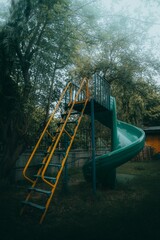 Playground with a slide, surrounded by lush green grass