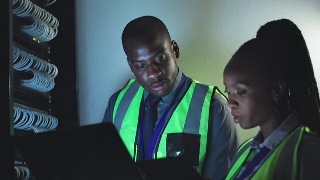 People, manager and server room on laptop, information technology and cyber security or hardware solution. African man and woman for data cable, engineering power or electricity maintenance at night