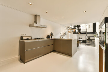 a modern kitchen area in a residential apartment with white flooring and black appliances on the counters, cabinets and drawers