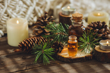 Cedar and spruce organic essential oil in small glass bottles on wooden background. Concept of pure...