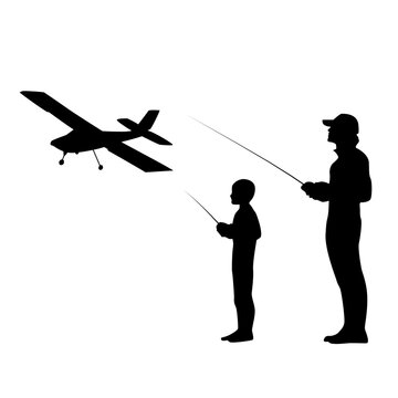Silhouette of an adult and child flying a remote-control aircraft