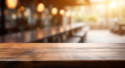 Empty wooden tabletop and defocused background with bokeh lights blurred backdrop of street cafe and beer pub.