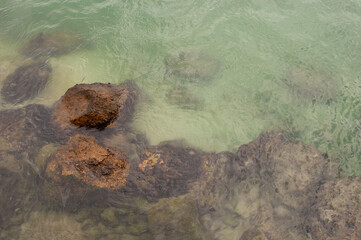Sea view from above coastline with underwater rocks in Syracuse, Sicily, Italy.